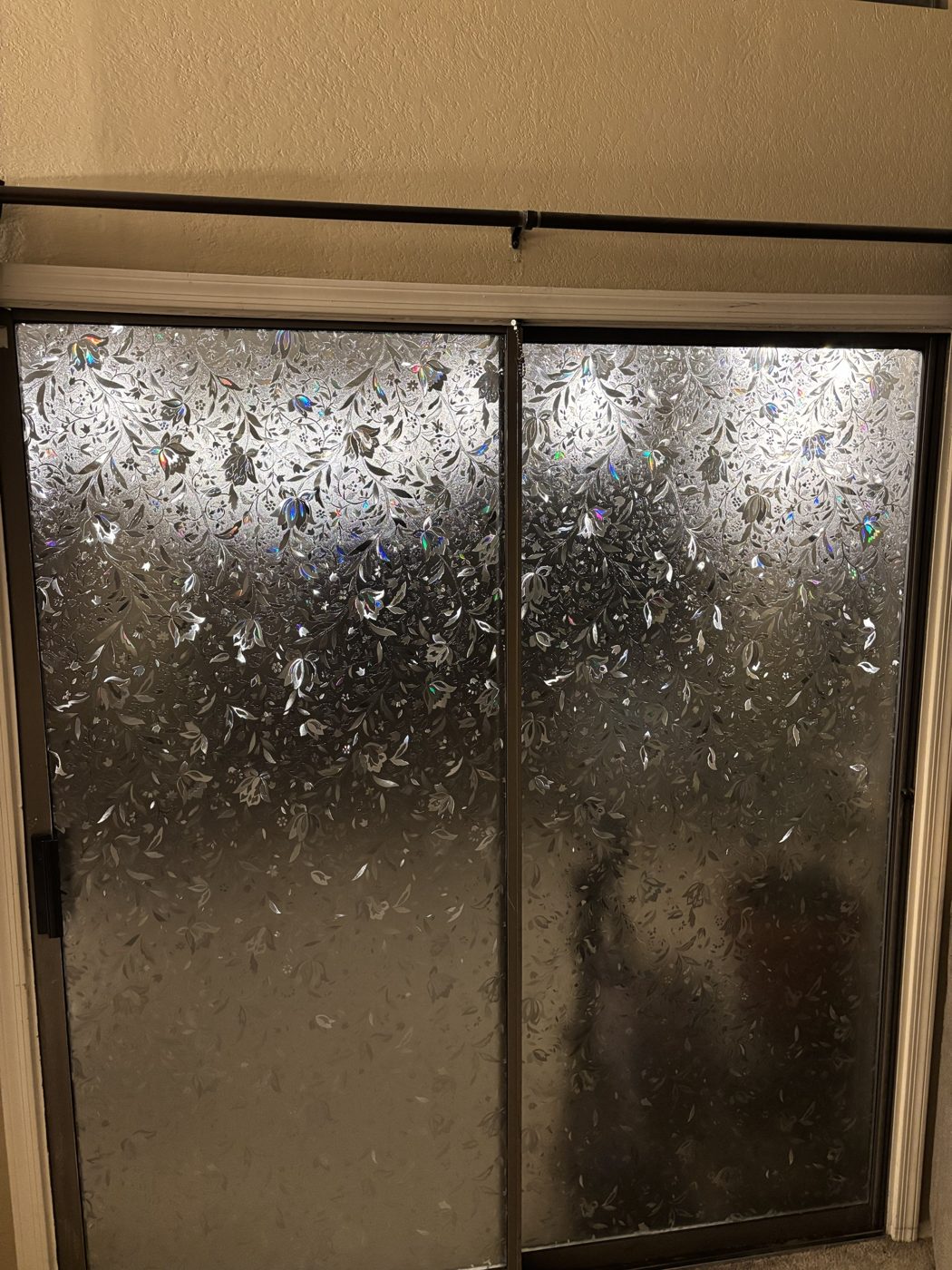 Sliding glass door with decorative floral privacy film