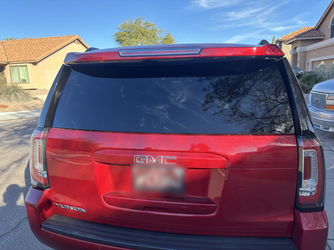 Rear window tint on a red GMC Yukon